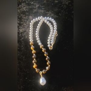 White pearls and tiger eye beads.